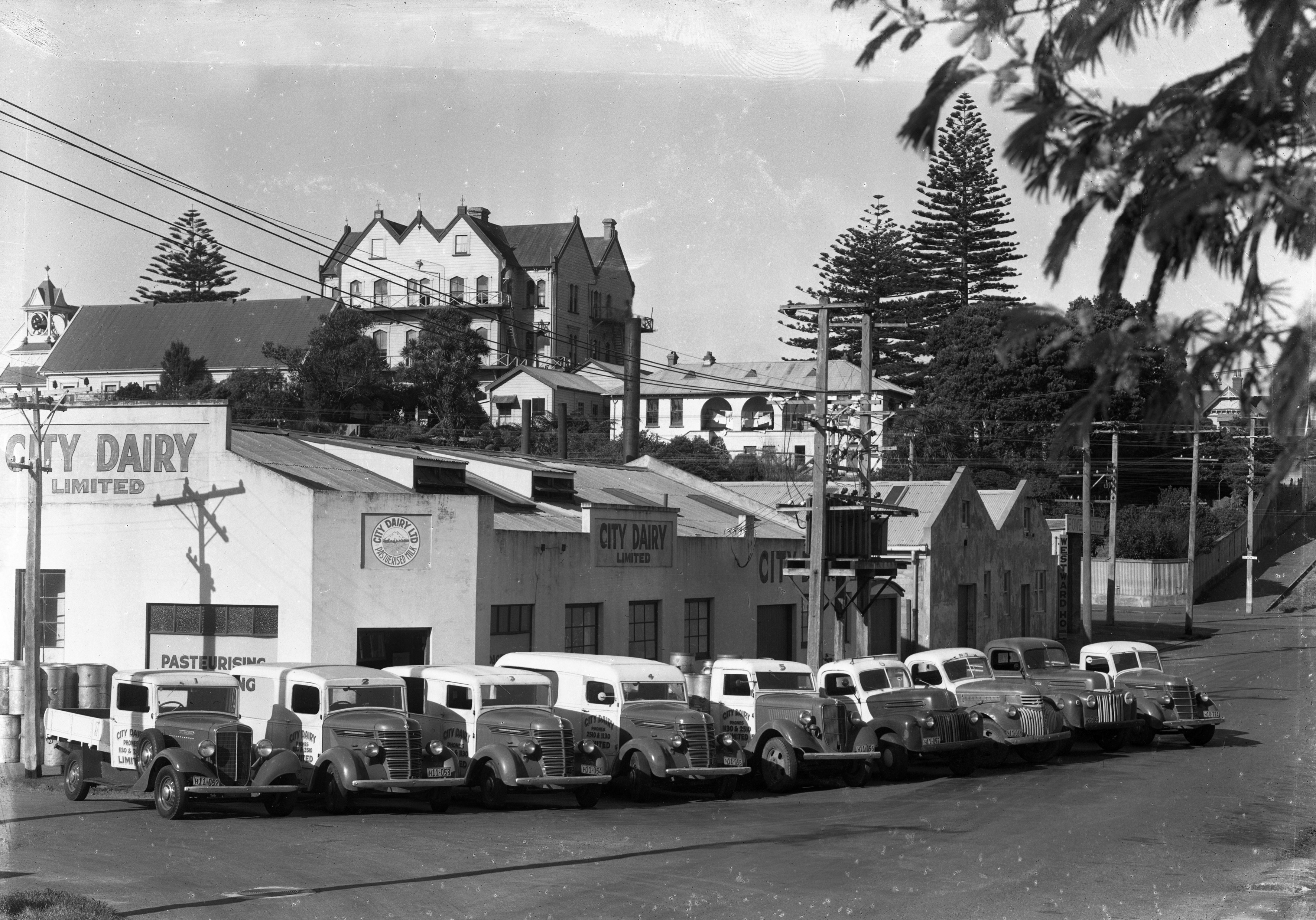 View of City Dairy on the corner of Dawson and King Streets with the convent in the background (30 June 1947). Swainson's Studios. Collection of Puke Ariki (SW1947.0141).