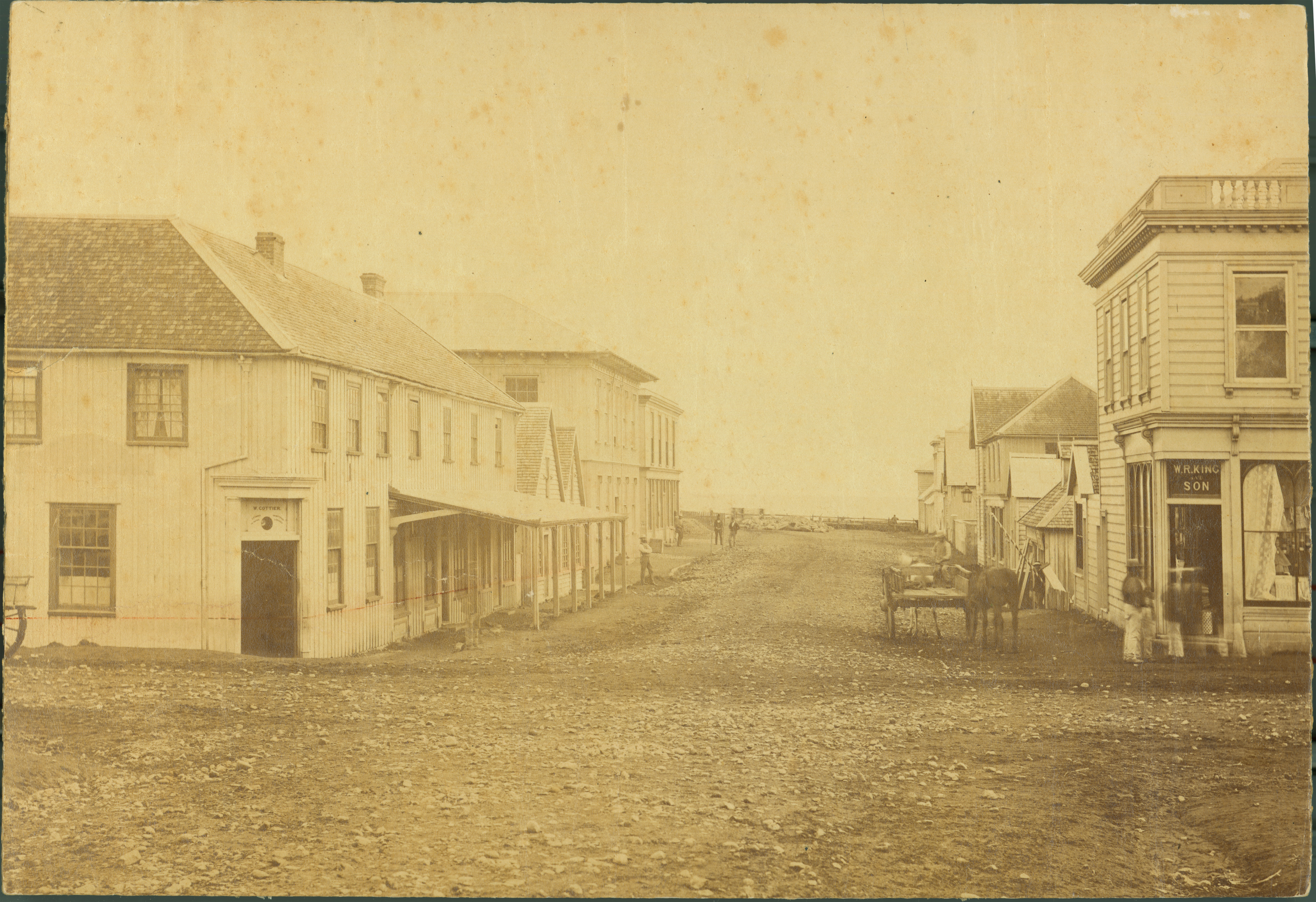 View of lower Brougham Street looking towards the sea with the Provincial Council building visible on the left (1870s). William Andrews Collis. Collection of Puke Ariki (PHO2001-96).