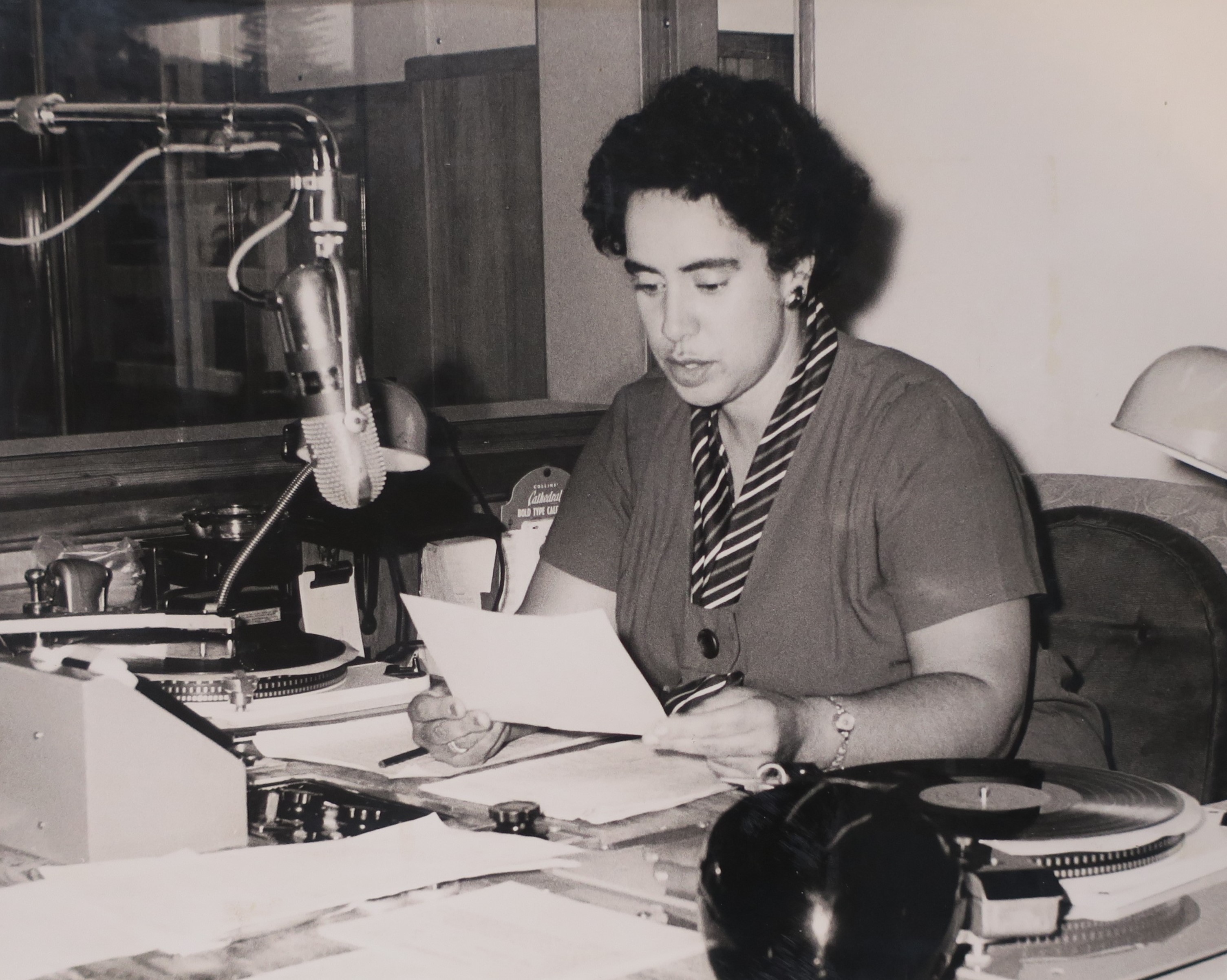 Marama presenting a listeners' request session on 2XP Radio Taranaki. Unknown photographer. Collection of Puke Ariki (ARC2003-215).