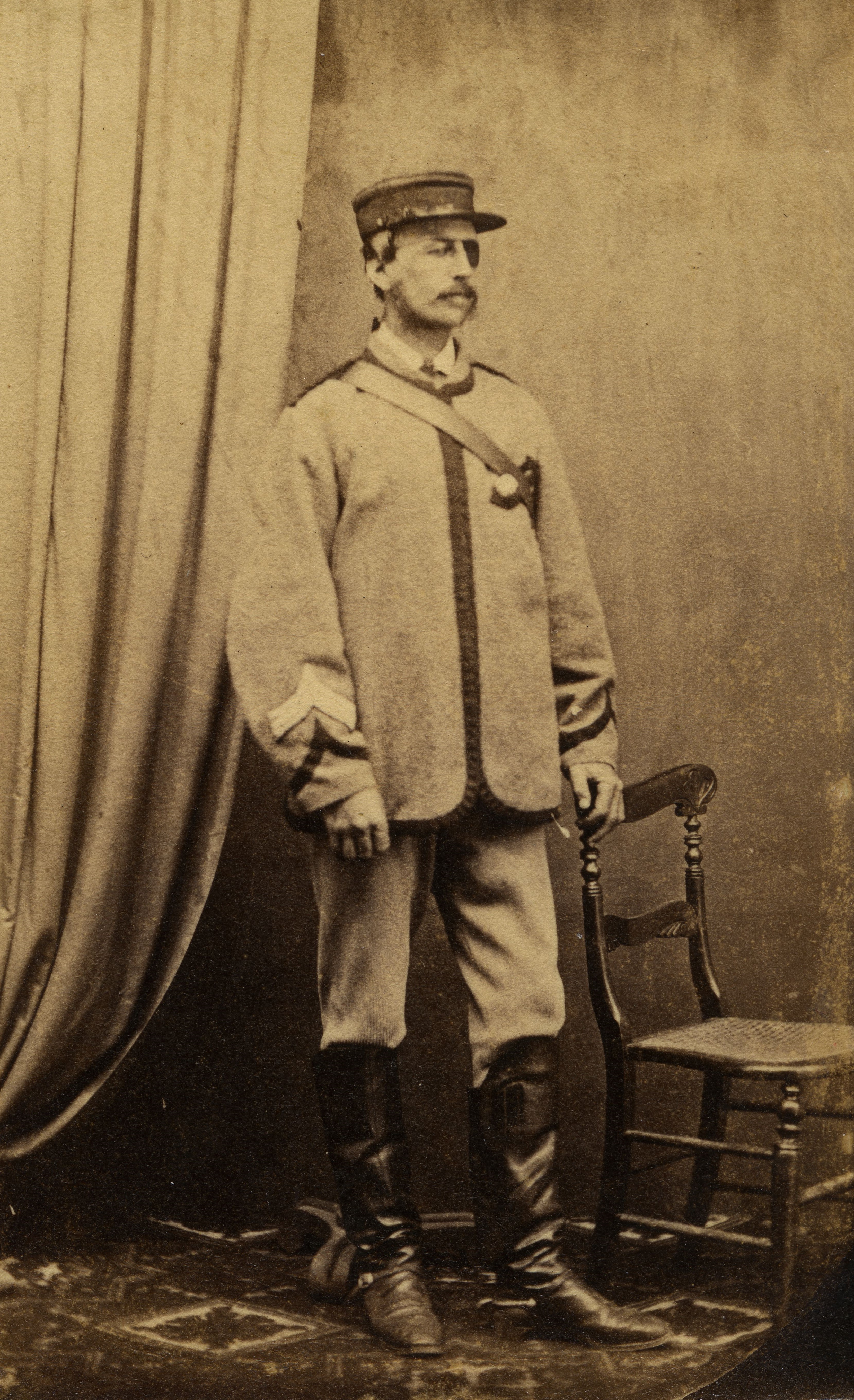 William Johnston (1839-1914) wearing military uniform and an eye patch (1860s). Unknown photographer. Collection of Puke Ariki (PHO2012-0498).