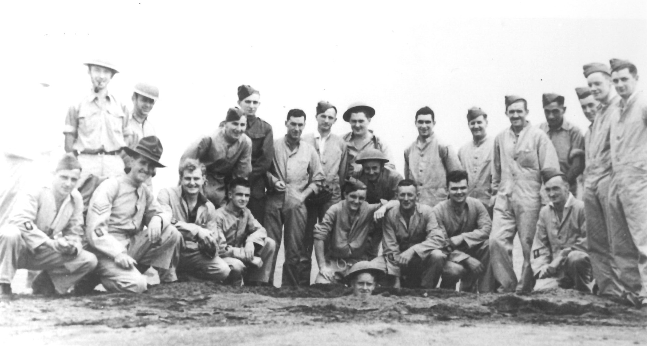 Members of the 2C Section Bomb Disposal Group beside a crater made after exploding an anti-personnel bomb at Bell Block (14 February 1943). Unknown photographer. Collection of Puke Ariki (ARC2002-10).