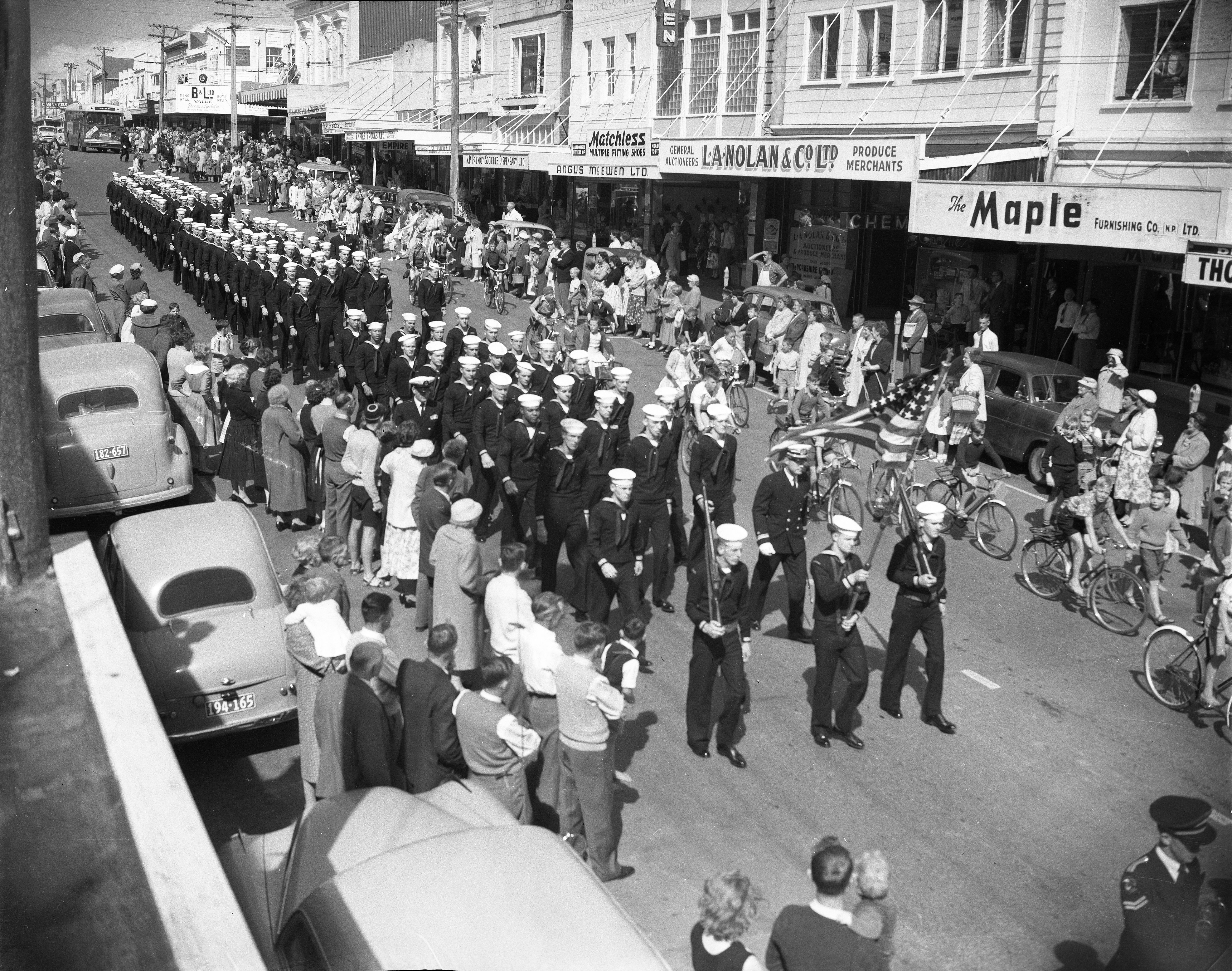 Parade of USS Staten Island sailors on Devon Street, New Plymouth (18 November 1958). Unknown photographer. Collection of Puke Ariki (PHO2010-0206).