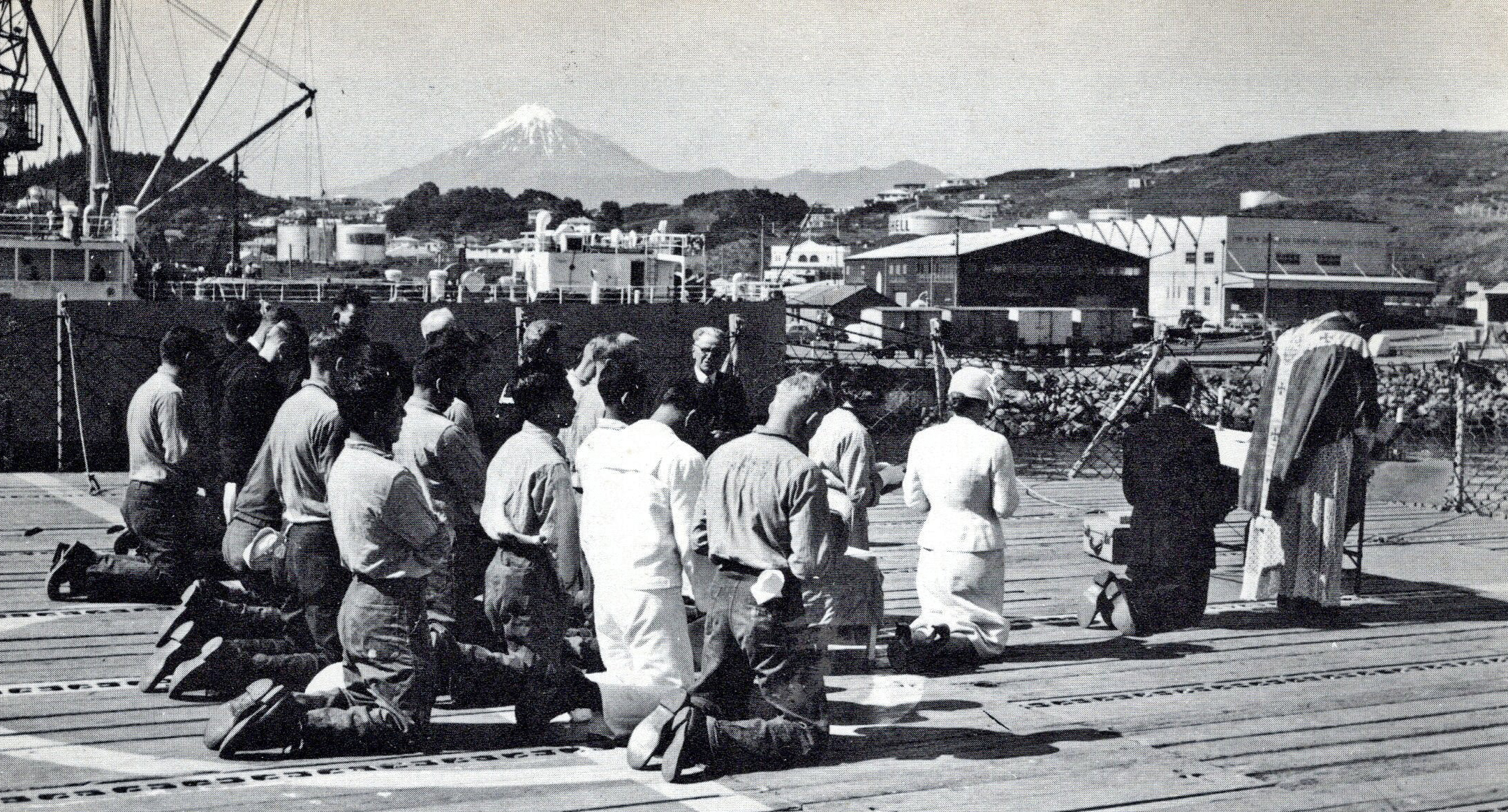 Father Austin holding a mass on deck for Catholic crew (November 1958). Unknown photographer. USS Staten Island commemorative cruise book courtesy of Jim Freund.