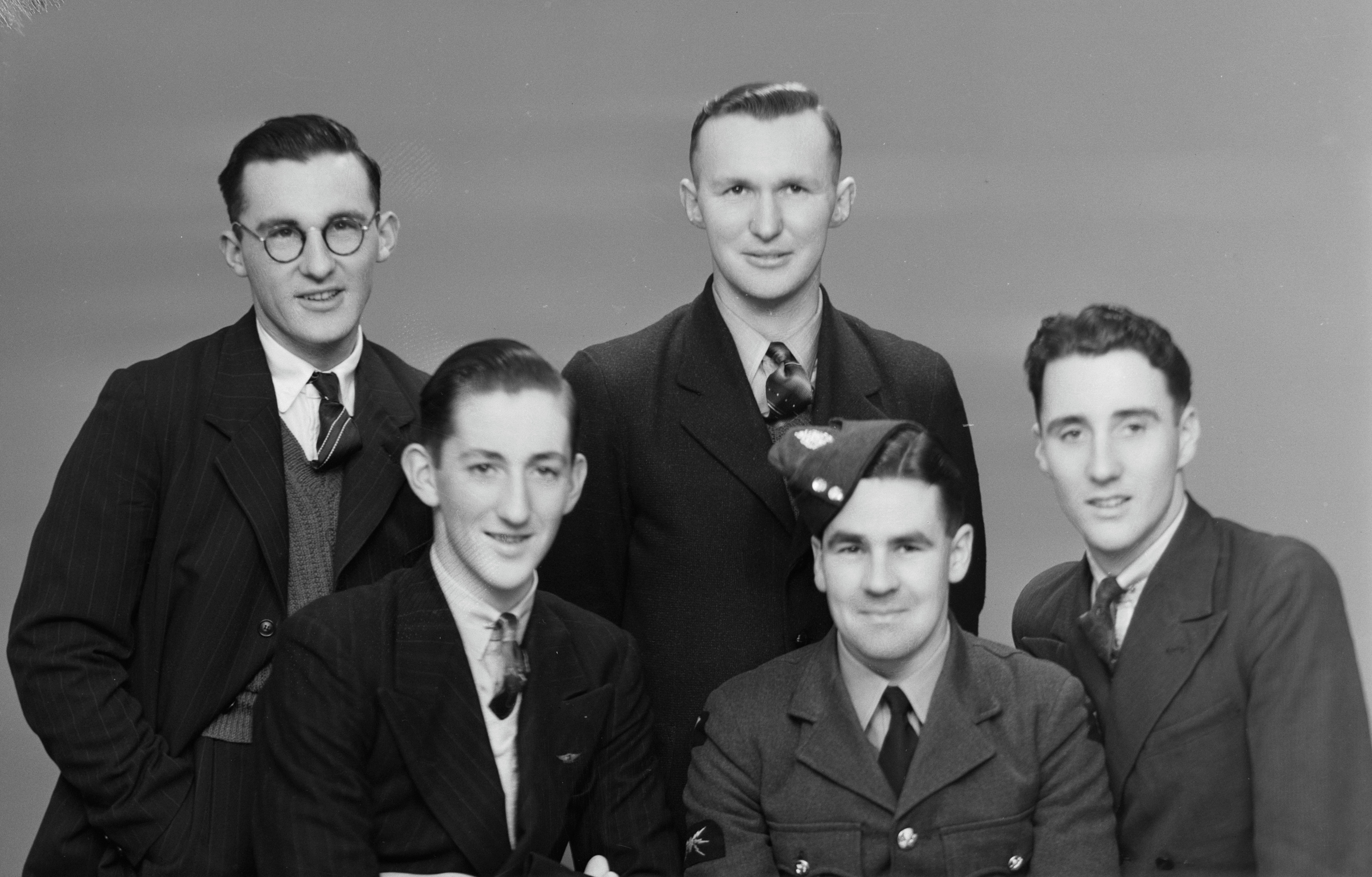 Martin Kilpatrick standing third from left with (from left) his brother Joseph and friends Frank Scott, Jim Priest (wearing uniform) and Alan Scott (1940s). Swainson's Studios. Collection of Puke Ariki (SW1923-1965.00501d).